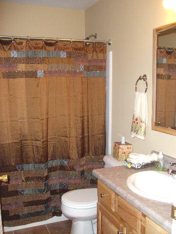 394 Evergreen Drive Rifle, CO 81650 - Photo 9 of 9 a bathroom with a granite countertop sink a toilet and shower