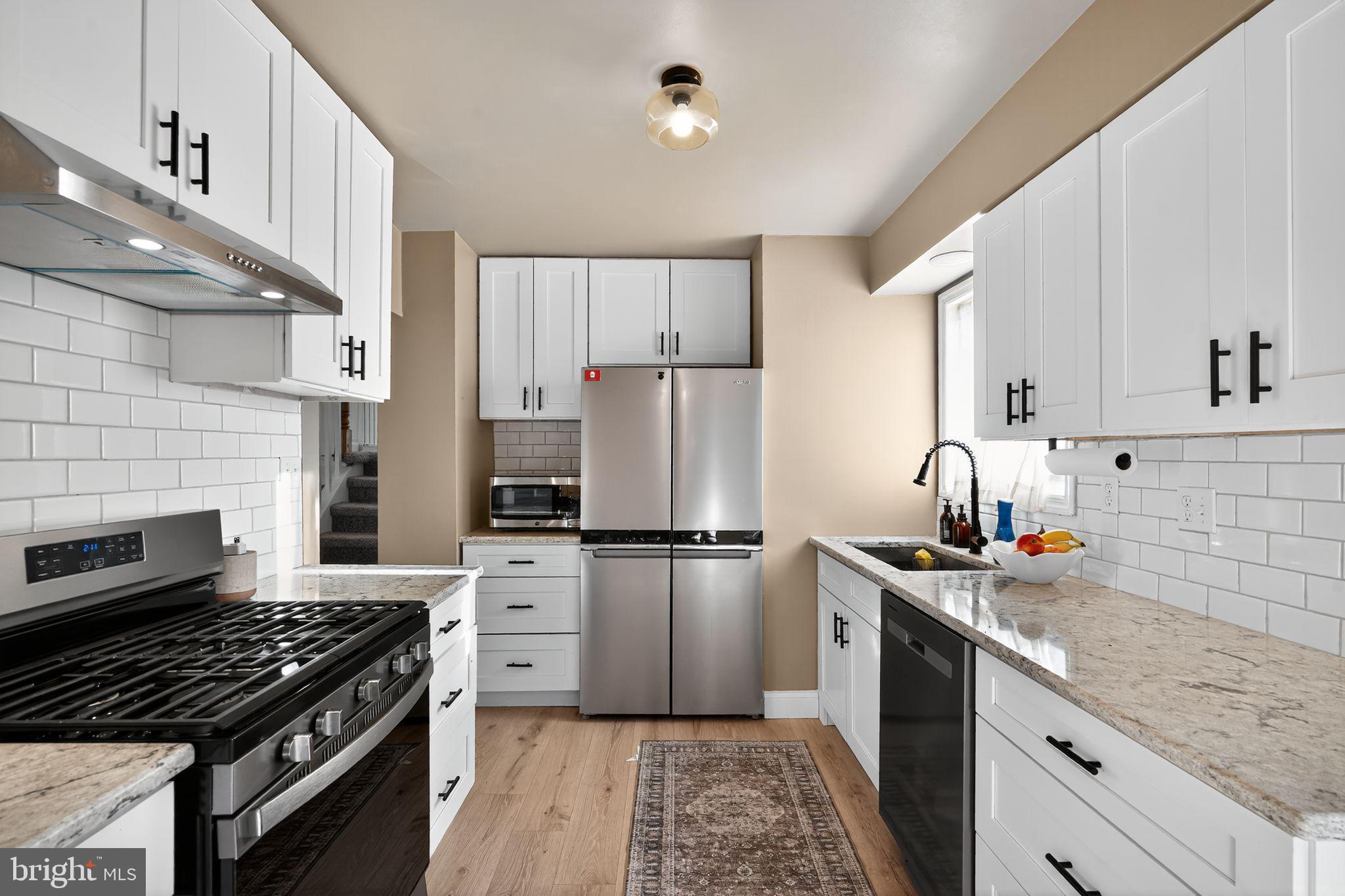 333 Jackson Road Mantua, NJ 08051 - Photo 21 of 34 a kitchen with a stove a refrigerator and a sink