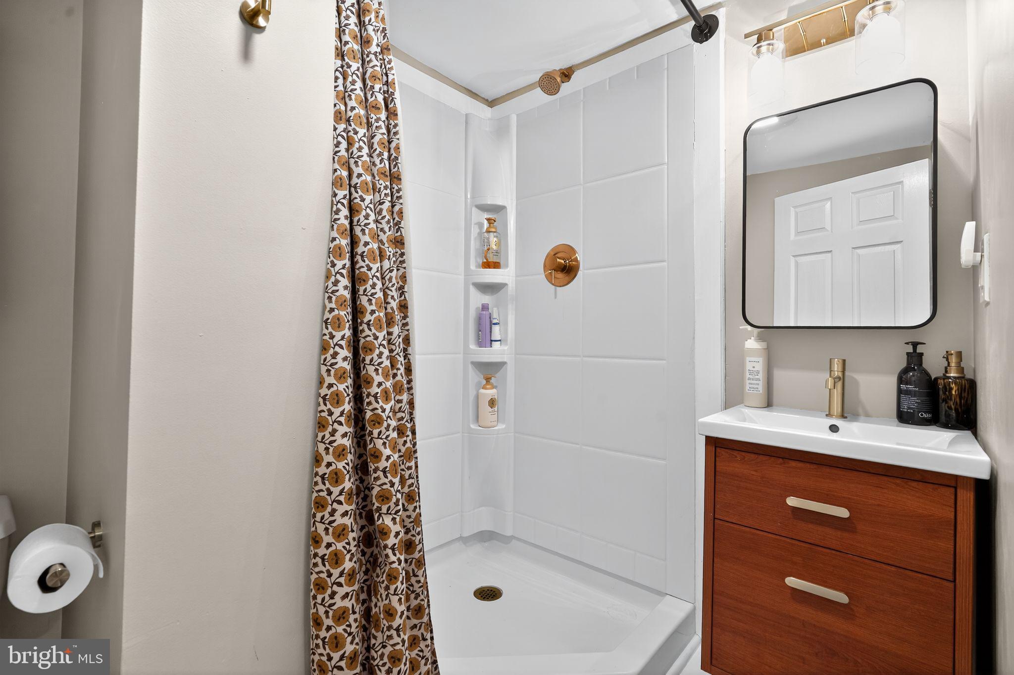 333 Jackson Road Mantua, NJ 08051 - Photo 24 of 34 a bathroom with a shower a sink and a mirror