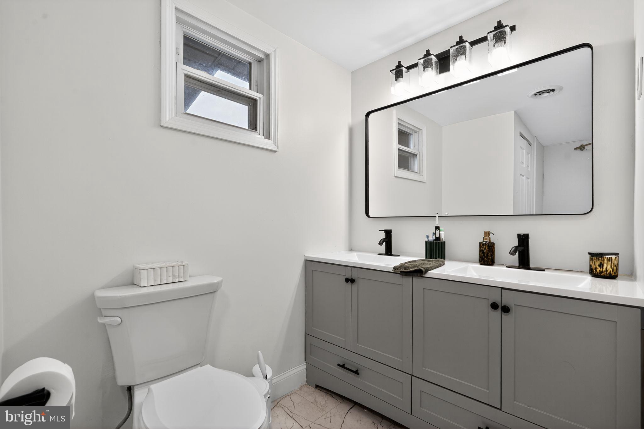 333 Jackson Road Mantua, NJ 08051 - Photo 34 of 34 a bathroom with a toilet sink and mirror