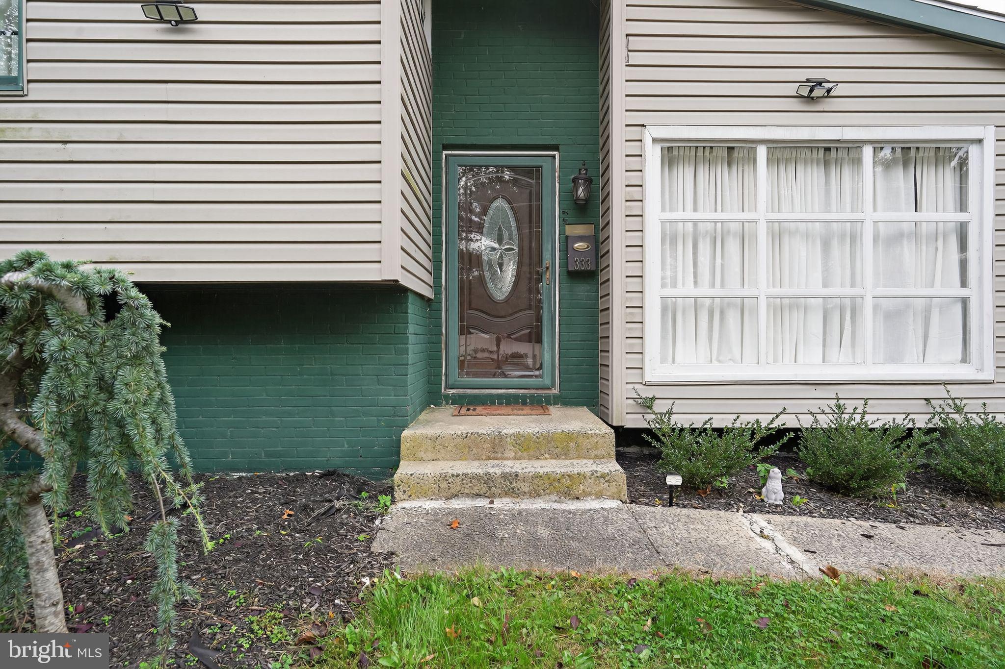 333 Jackson Road Mantua, NJ 08051 - Photo 5 of 34 a front view of a house with a garden