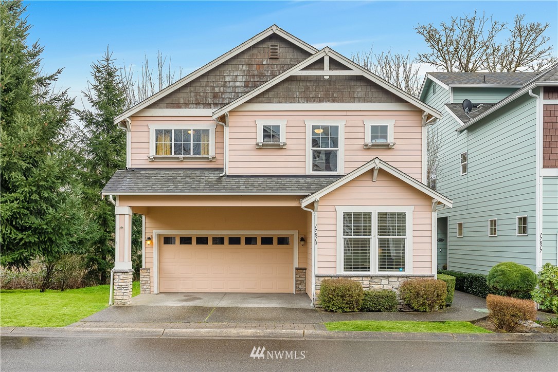 17813 20th Avenue Southeast, Unit 57 Bothell, WA 98012 - Photo 1 of 25 a front view of a house with a garden and plants