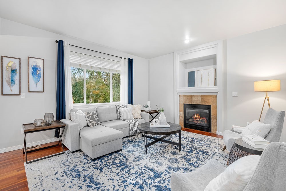 17813 20th Avenue Southeast, Unit 57 Bothell, WA 98012 - Photo 13 of 25 a living room with furniture and a fireplace