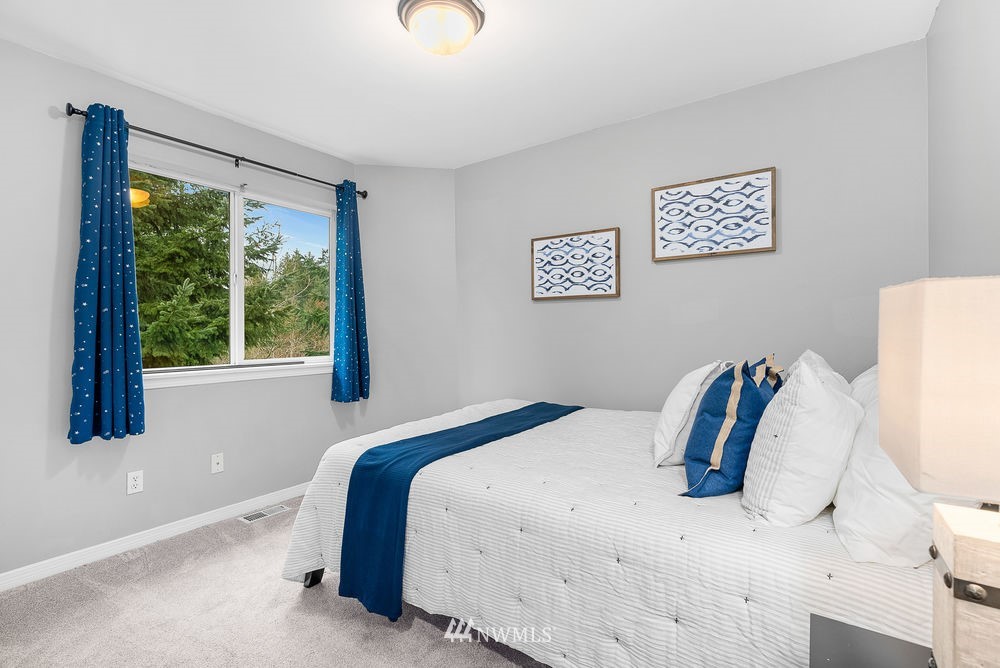 17813 20th Avenue Southeast, Unit 57 Bothell, WA 98012 - Photo 21 of 25 a bedroom with a bed and a large window