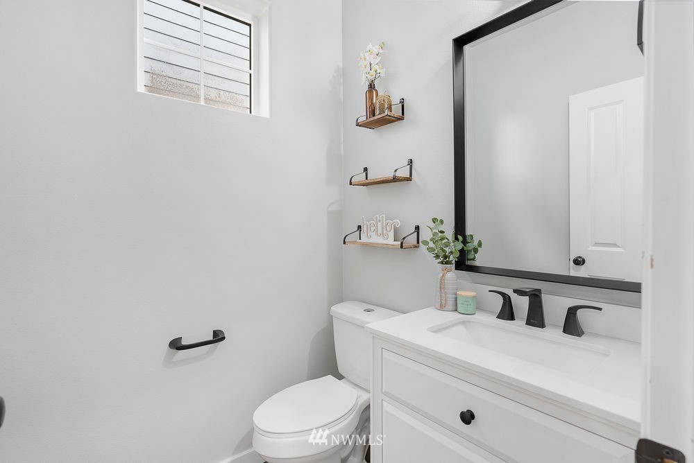 17813 20th Avenue Southeast, Unit 57 Bothell, WA 98012 - Photo 4 of 25 a bathroom with a sink a toilet and mirror