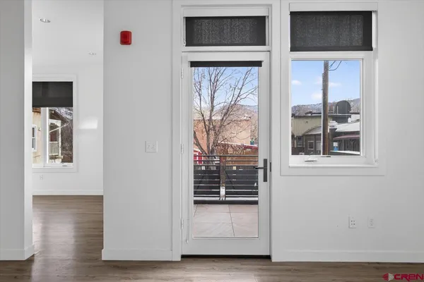 a view of an entryway with wooden floor