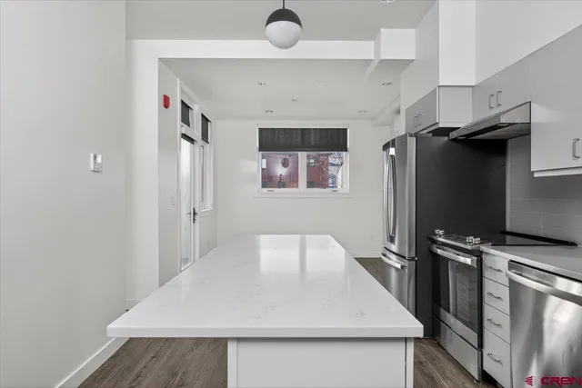 a kitchen with a refrigerator and a sink