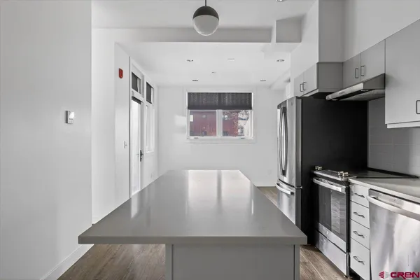 a view of a kitchen with a sink and cabinet
