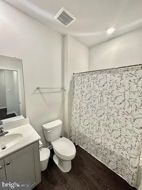 a white toilet sitting next to a bathroom sink