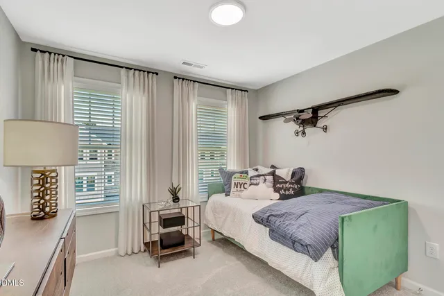 a bedroom with a bed and a lamp with window