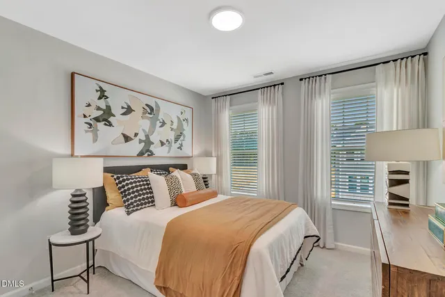 a bedroom with a bed and a painting on the wall