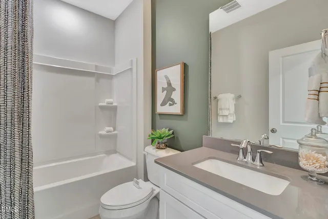 a bathroom with a granite countertop sink toilet tub and shower