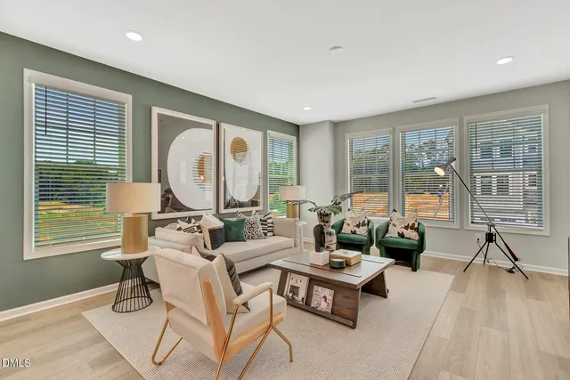 a living room with fireplace furniture and a large window