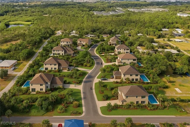 an aerial view of residential houses with outdoor space and swimming pool