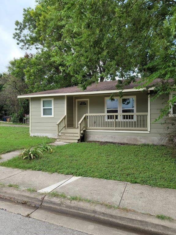 1410 Singleton Avenue Austin, TX 78702 - Photo 1 of 7 a front view of a house with a garden and yard