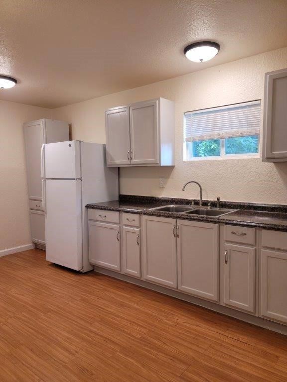 1410 Singleton Avenue Austin, TX 78702 - Photo 4 of 7 a kitchen with granite countertop a refrigerator and a sink
