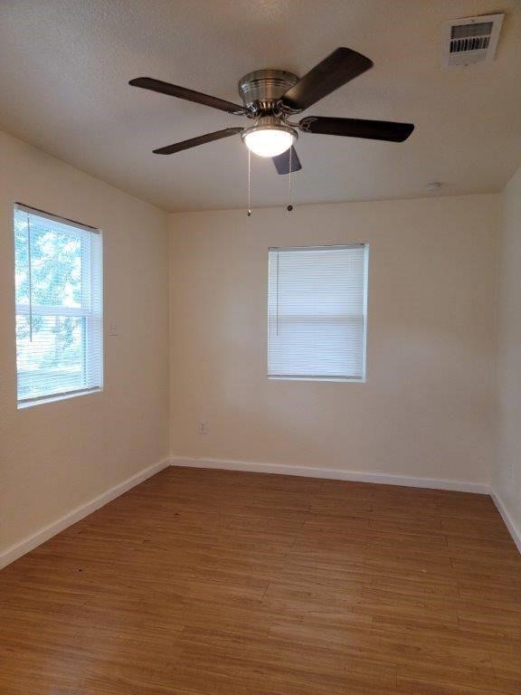 1410 Singleton Avenue Austin, TX 78702 - Photo 5 of 7 a view of an empty room with a window and wooden floor