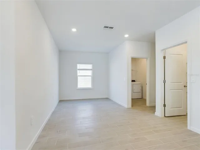 an empty room with a bathroom and a sink