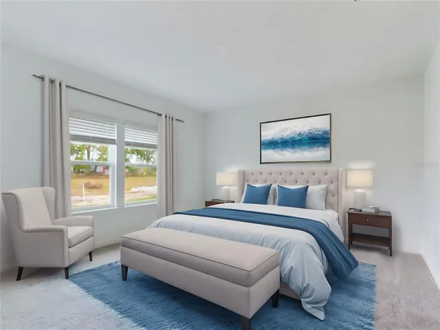 a bedroom with a bed and a couch with window