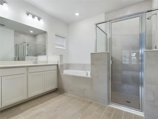 a bathroom with a granite countertop sink mirror and shower