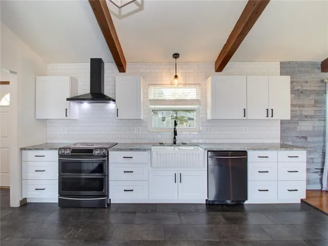 a kitchen with stainless steel appliances a stove and a refrigerator