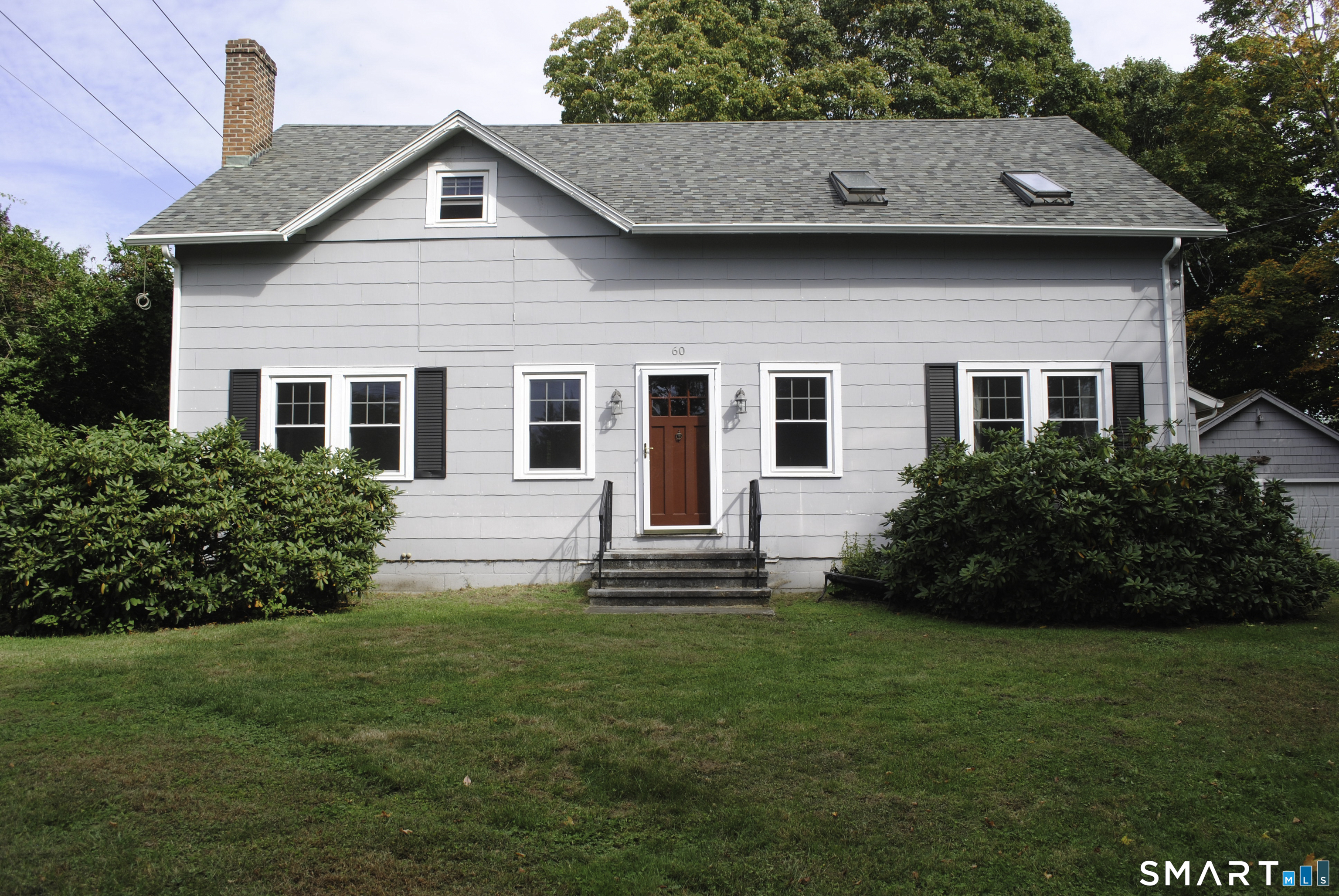60 Grove Street, Unit B Clinton, CT 06413 - Photo 1 of 11 a front view of a house with a garden