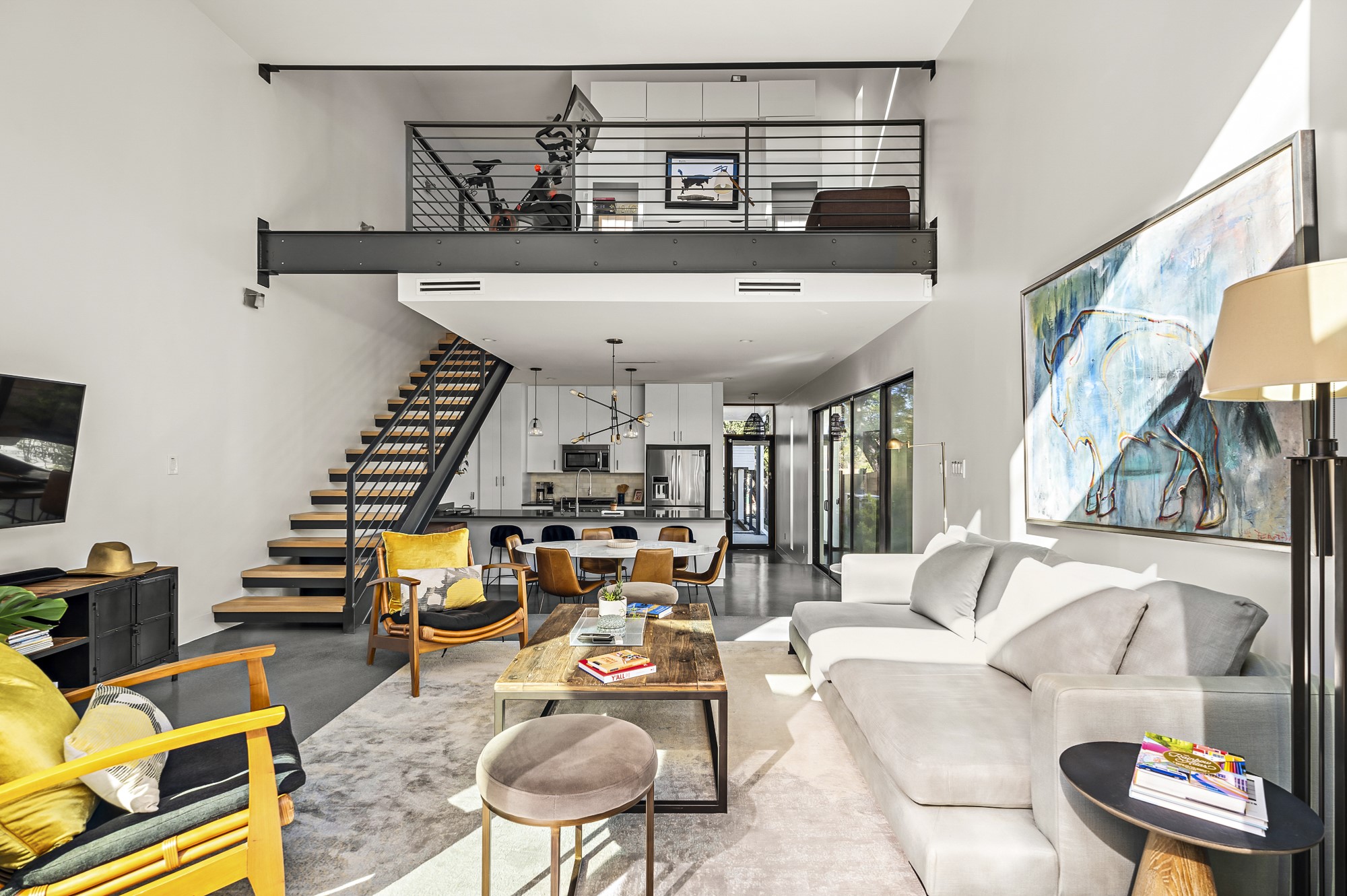 2411 Euclid Avenue, Unit A Austin, TX 78704 - Photo 14 of 40 Open-concept living space anchored by a sculptural floating staircase