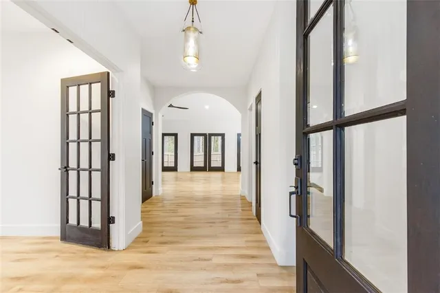 a view of a hallway with wooden floor and staircase