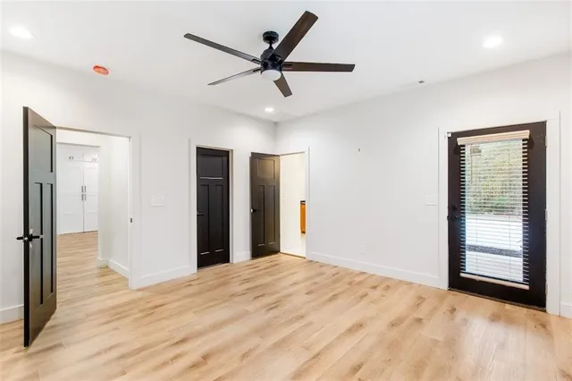 a view of a livingroom with a ceiling fan and window