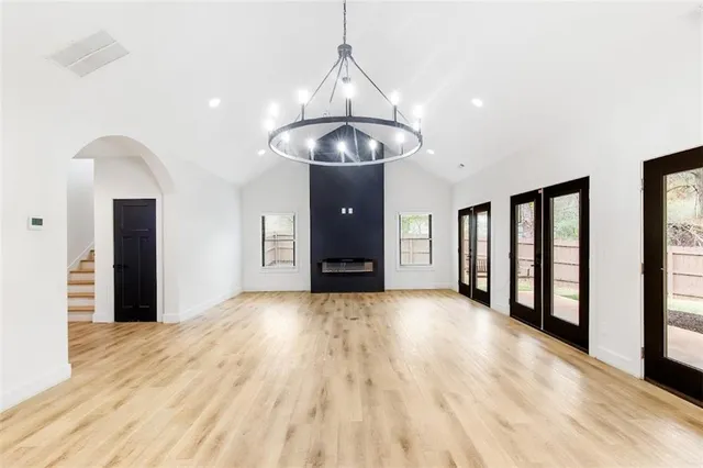 a view of a room with wooden floor and large windows
