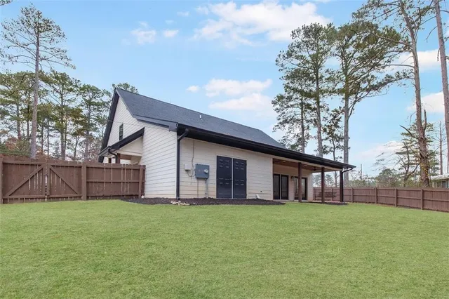 a view of a house with a yard and sitting area