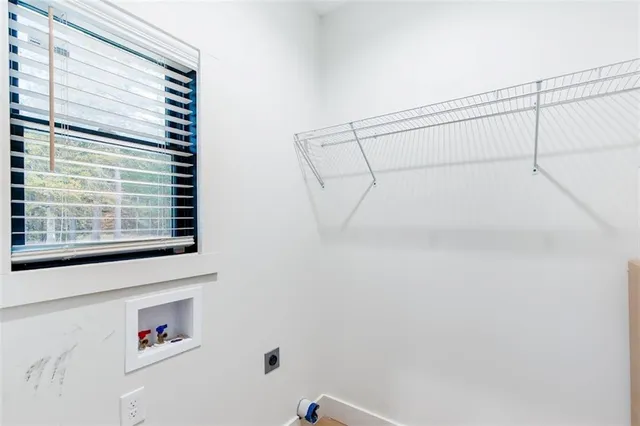 a view of storage and utility room with a window