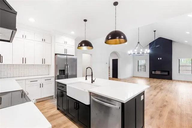 a kitchen with a sink center island and stainless steel appliances