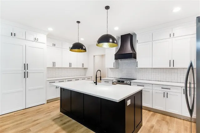 a kitchen with a sink a stove and cabinets