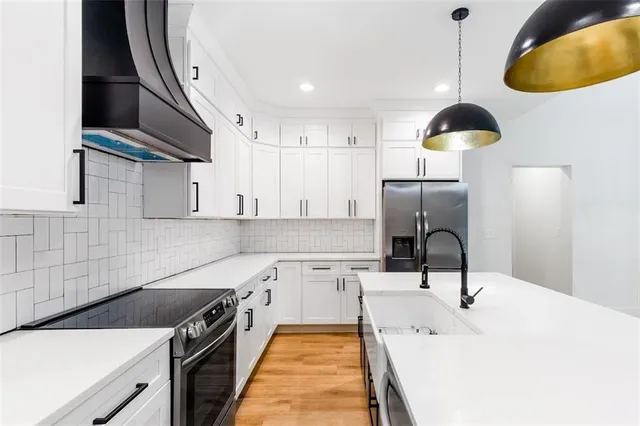 a kitchen with a sink appliances and cabinets