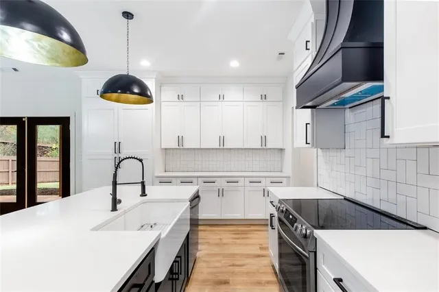 a kitchen with a sink stainless steel appliances and cabinets