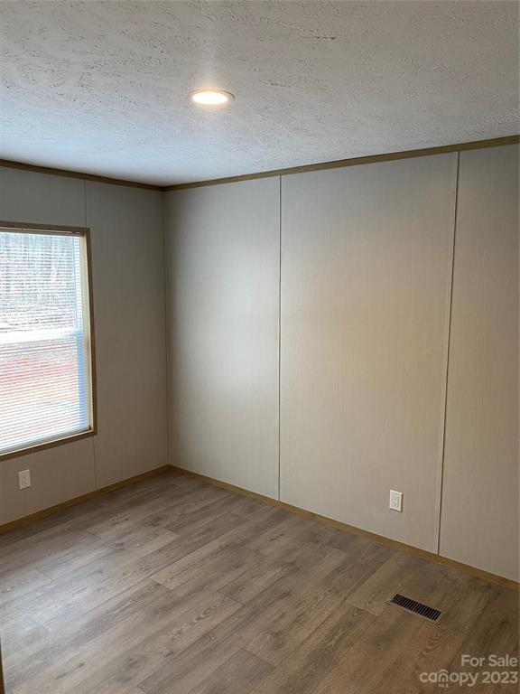 592 Tight Run Loop Rd Union Mills Union Mills, NC 28167 - Photo 16 of 25 an empty room with wooden floor and windows