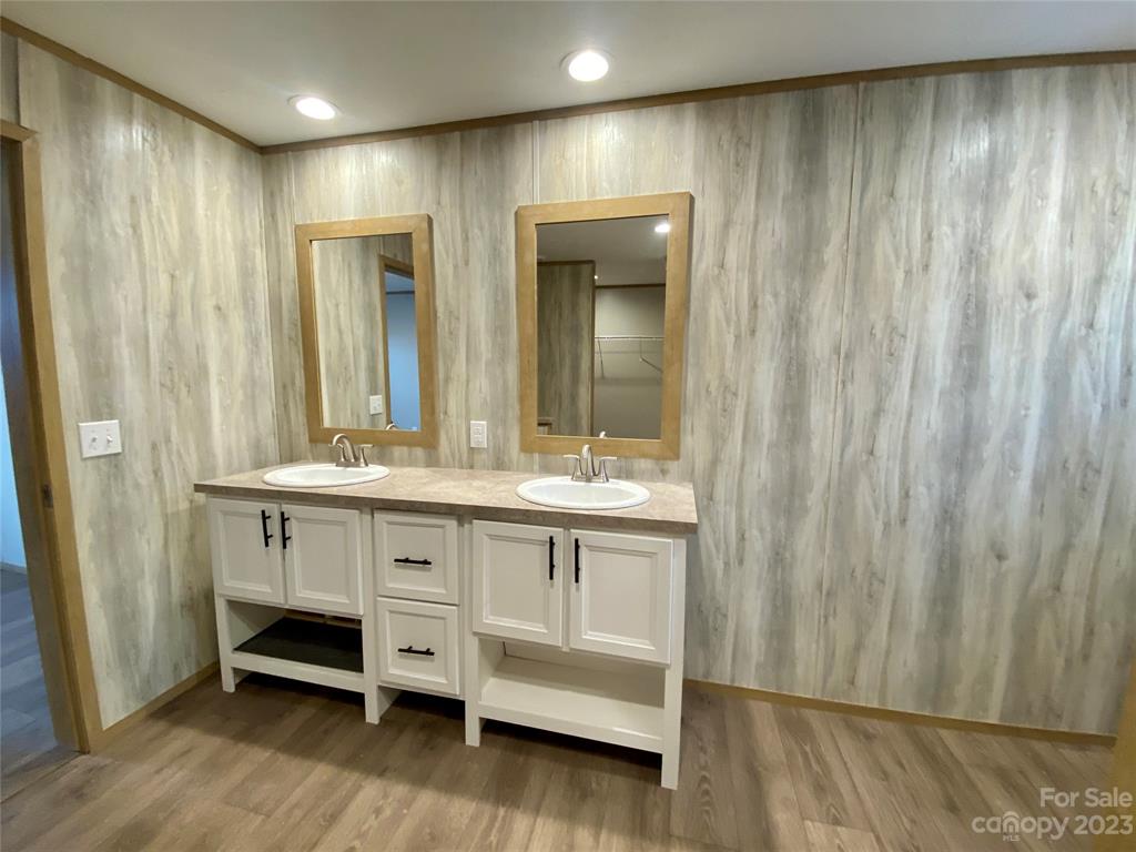 592 Tight Run Loop Rd Union Mills Union Mills, NC 28167 - Photo 20 of 25 a bathroom with a double vanity sink and a mirror