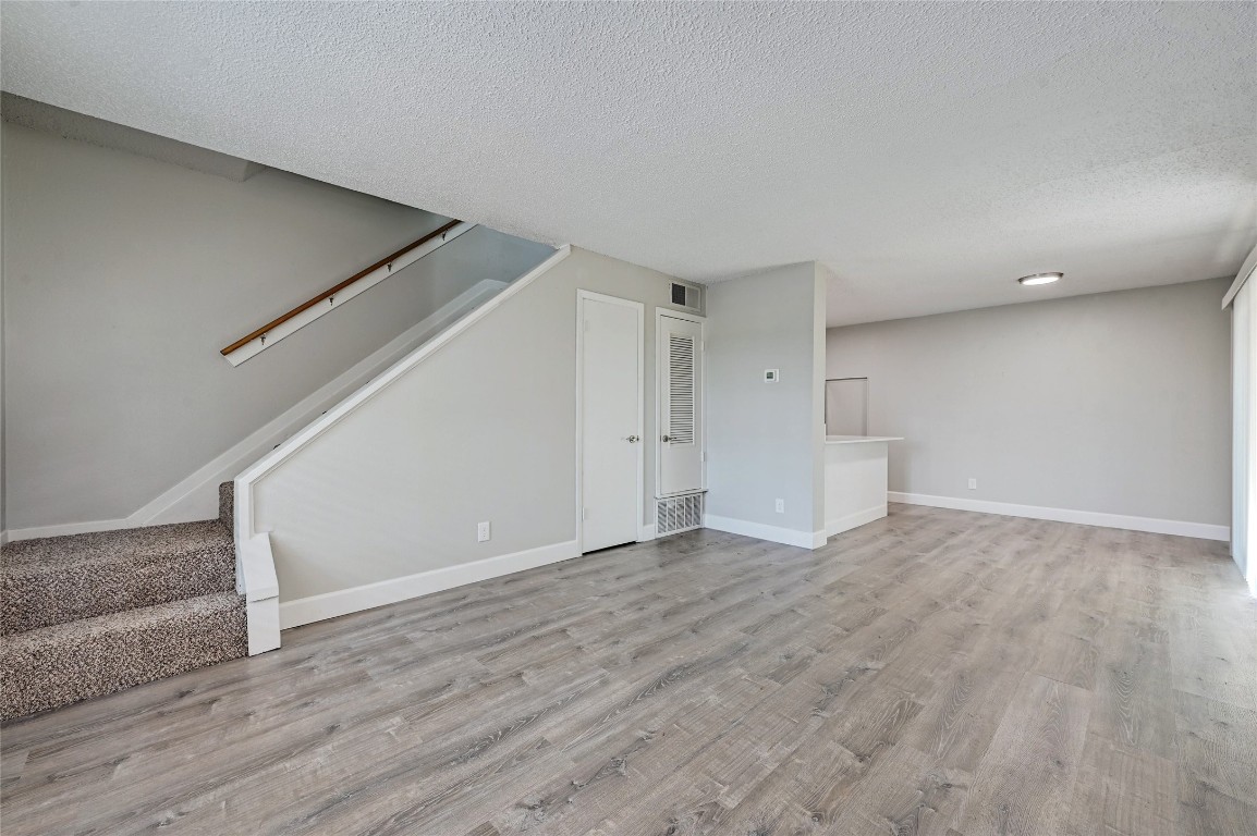 1200 Banister Lane, Unit 5 Austin, TX 78704 - Photo 3 of 13 a view of empty room with wooden floor
