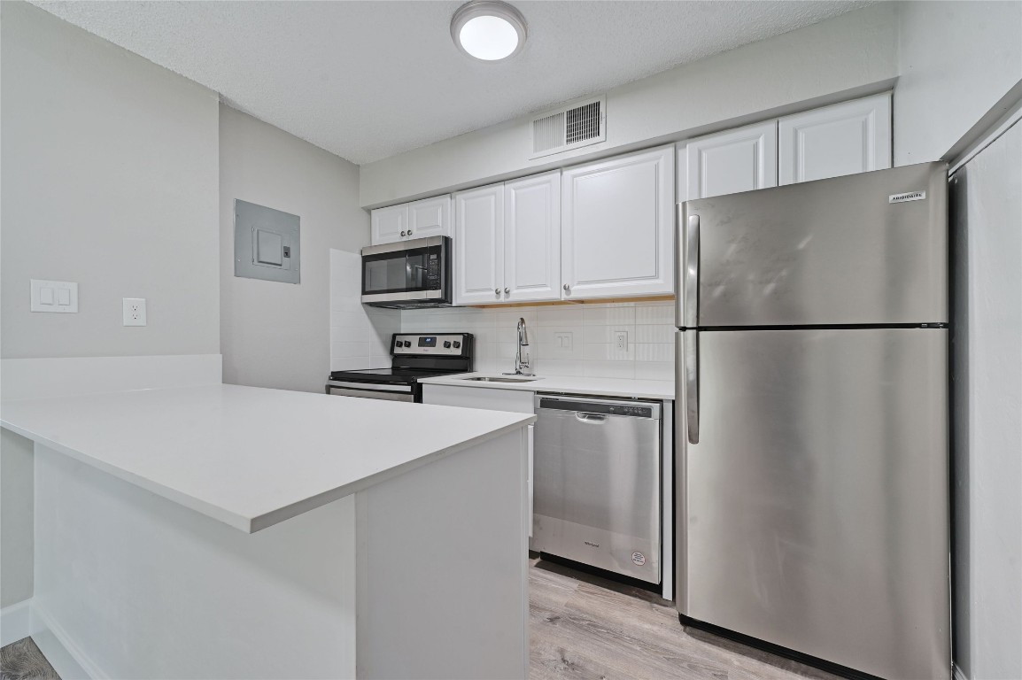 1200 Banister Lane, Unit 5 Austin, TX 78704 - Photo 7 of 13 a white refrigerator freezer sitting in a kitchen