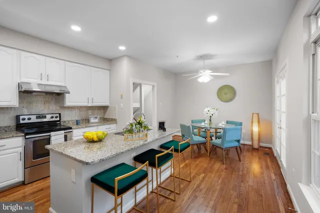 a kitchen with a wooden table and chairs