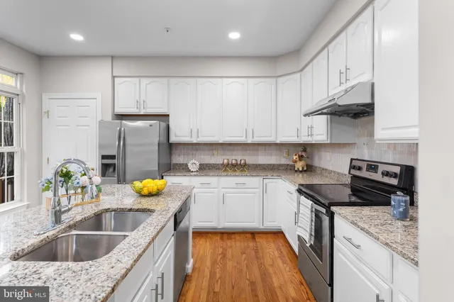 a kitchen with a sink a stove and refrigerator