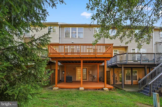 a view of a house with a yard and deck