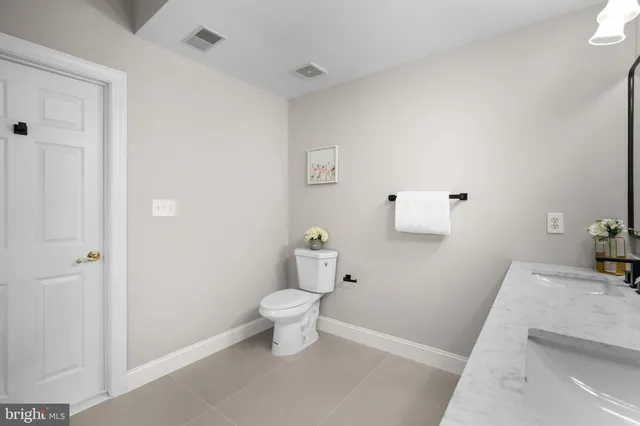 a bathroom with a bathtub sink mirror vanity and toilet