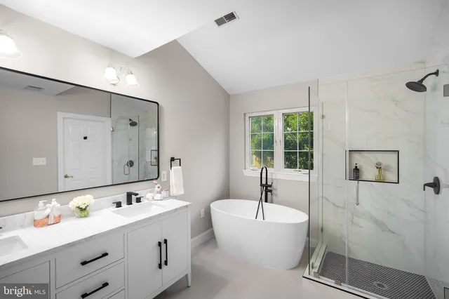 a bath tub sitting next to a white sink