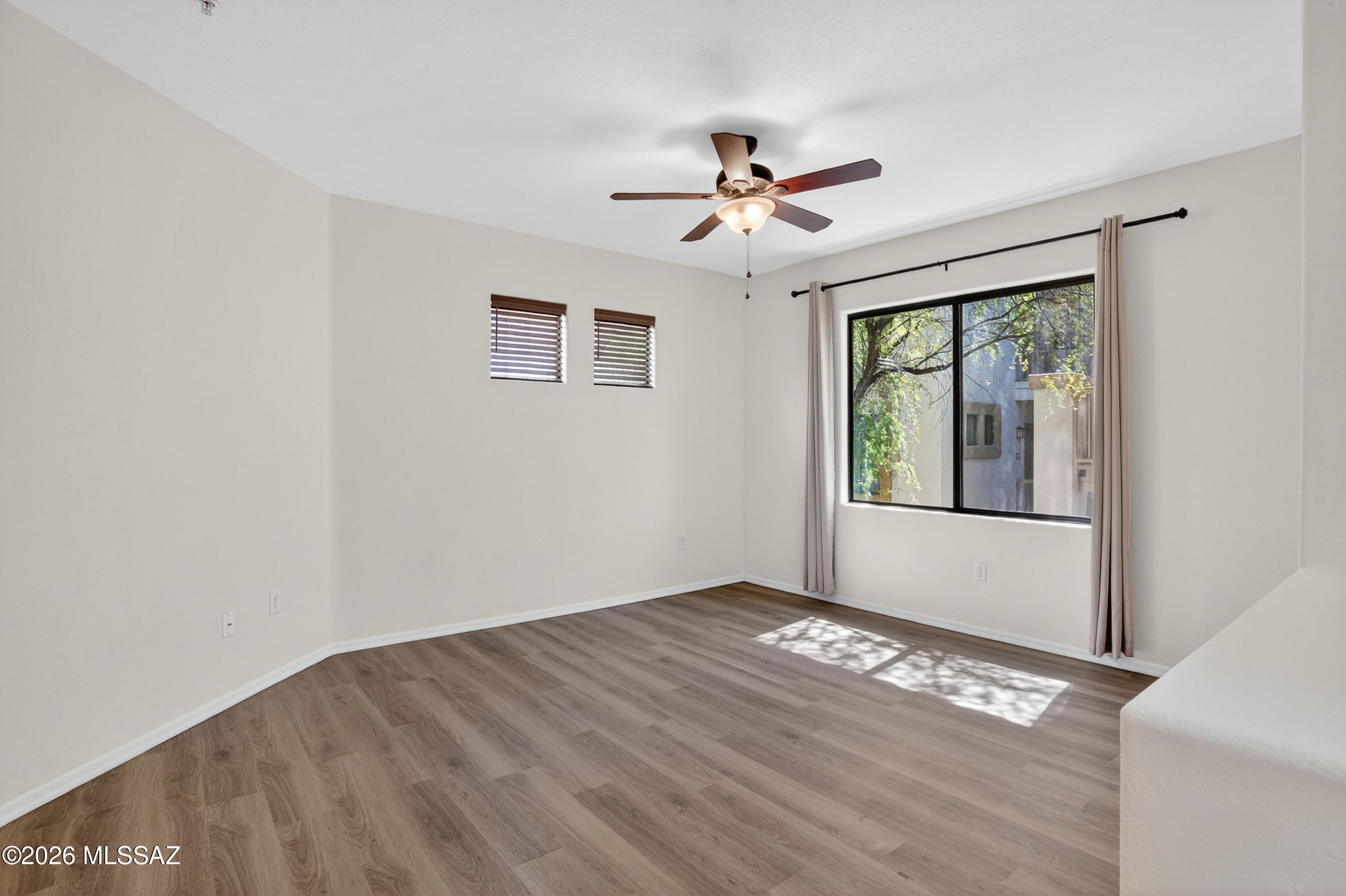 2550 East River Road, Unit 4204 Tucson, AZ 85718 - Photo 7 of 36 a view of empty room with wooden floor and fan