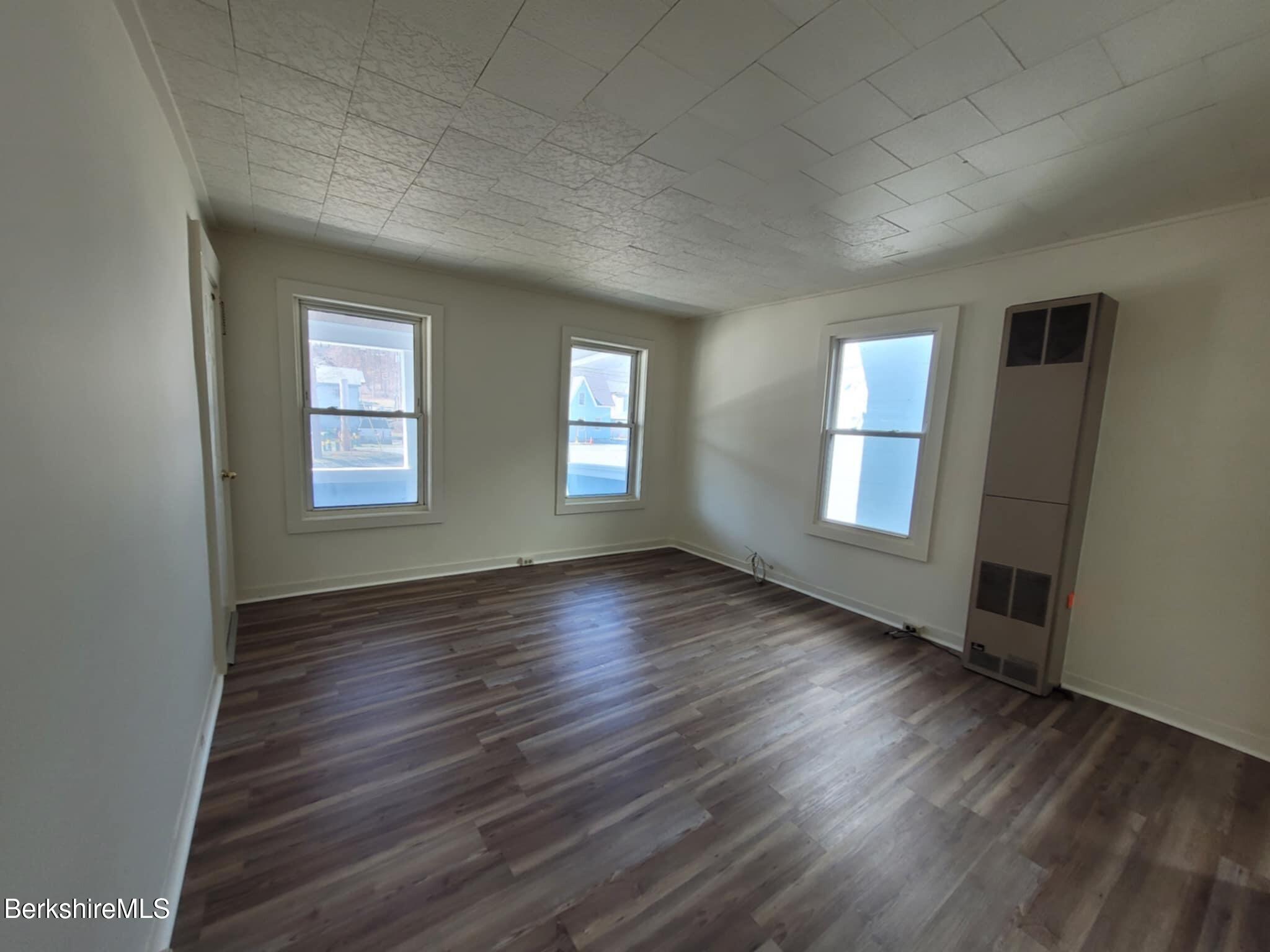35 Pleasant Street Adams, MA 01220 - Photo 4 of 7 an empty room with wooden floor and windows