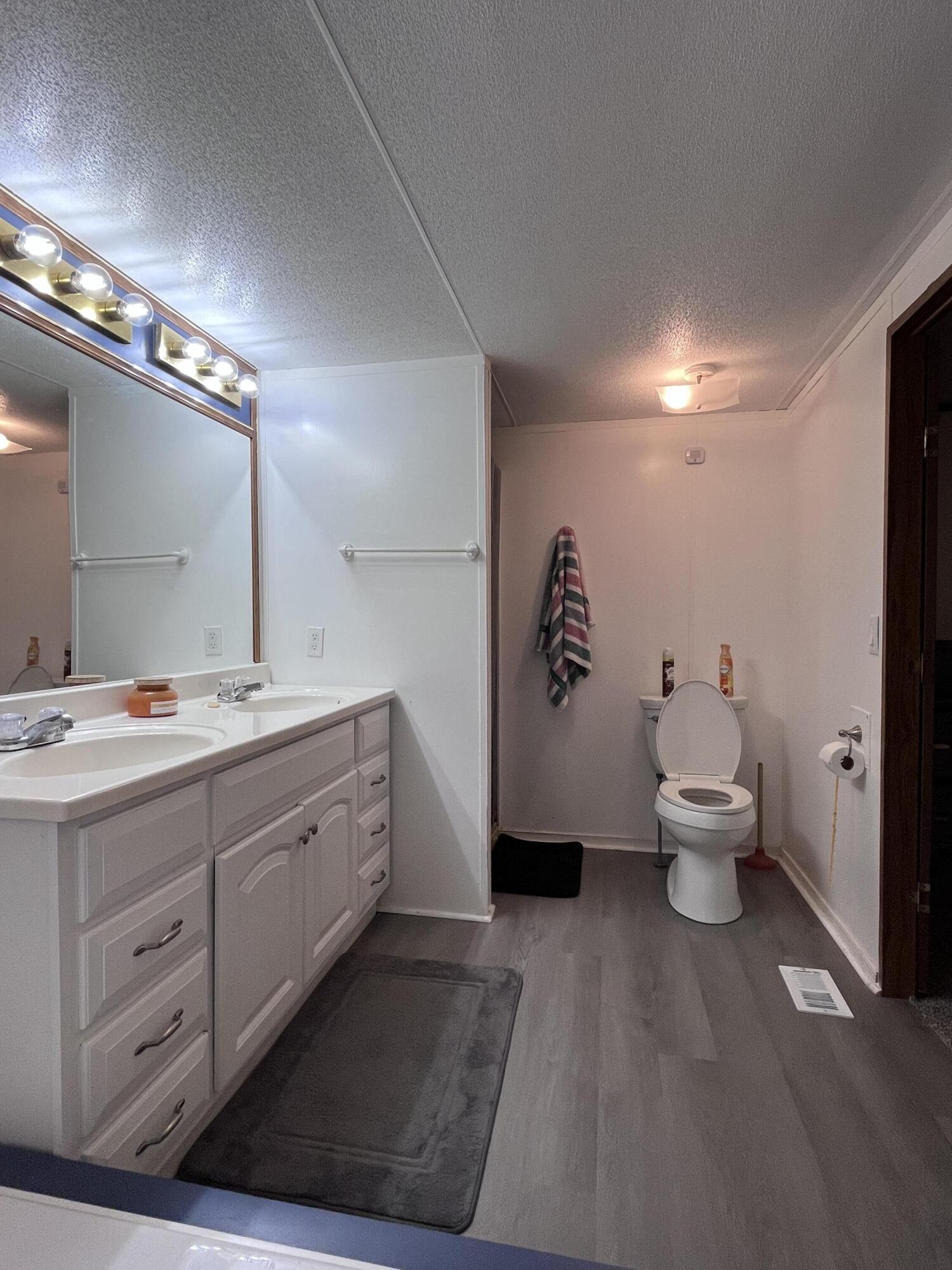 1923 Redwood Road Southeast Roanoke, VA 24014 - Photo 25 of 31 a spacious bathroom with a double vanity sink and a mirror