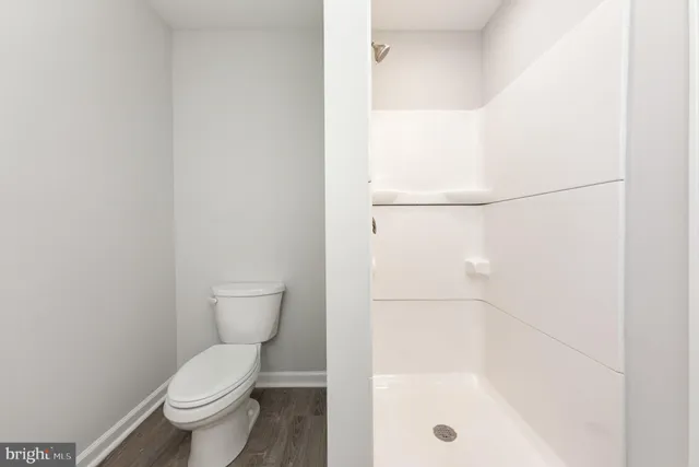 a bathroom with a toilet and a shower