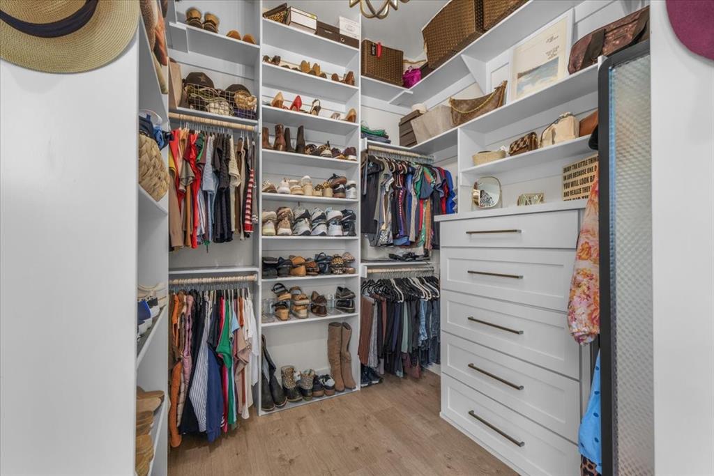 1059 Sweeney Way Weatherford, TX 76087 - Photo 17 of 37 Custom closet system featuring extensive shelving, multiple hanging rods, and built-in drawers with dark hardware